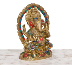 Brass Ganesha statue angled view, multicolor beads on arms and torso with halo