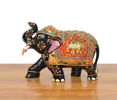 Wooden elephant showpiece in black with pink striped trunk and colorful side patterns