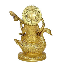 Golden brass Saraswati idol on swan base, detailed garment and lotus designs