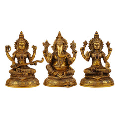 Brass idol set with three seated deities—Lakshmi, Ganesha, Saraswati—front view