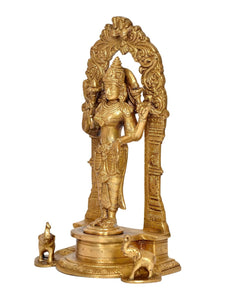 Brass Lakshmi-Laxmi statue side view with ornate arch and animal relief at the base
