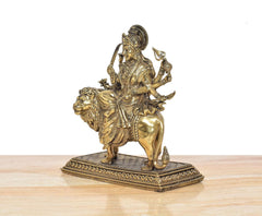 Brass Durga Maa statue in profile on lion, multi-armed, detailed jewelry