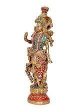 Brass Krishna idol figurine, side view holding flute, ornate crown and red-teal painted outfit