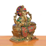 Brass Ganesha statue from rear three-quarter angle, multicolor painted jewelry, seated