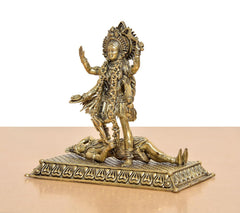 Mahakaali idol side view, ornate pedestal base with engraved border, arms raised