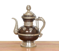 Brass teapot decorative spout and arched handle, engraved bands on dark brown body