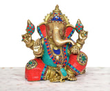 Ganpati Bappa brass statue showing raised hands and jeweled multicolor shoulder ornaments