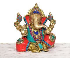 Ganpati Bappa brass statue showing raised hands and jeweled multicolor shoulder ornaments