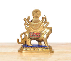 Rear view of brass Sherawali Mata on lion, jeweled straps and raised hands