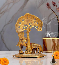 Gold metal Krishna near cow idol, decorative base with filigree tree trunk