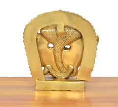 Brass Virat swaroop statue face detail, close-up of arched 15-face halo