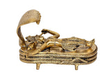 Brass Vishnu Yoga Nidra figure on circular base with raised cobra hood