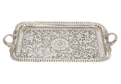 Decorative serving tray with central floral medallion and side handles