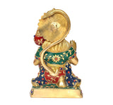 Back view of brass Hanuman statue, green-red patterned outfit and crown disc