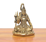 Brass Lord Shiva statue, seated blessing posture, trident at side, lion at base