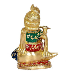 Krishna brass idol from behind, multicolor robe with blue feet, seated on shank