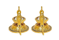 Gold-tone parrot diya lamp pair from side view with tall candle stems and bases