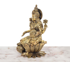 Superfine Brass Lakshmi idol, side view showing four arms and lotus seat detail