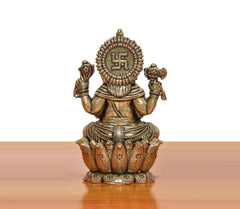 Bronze Ganesha idol back view with raised symbol on crown, four arms