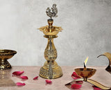 Brass peacock oil lamp stand with tiered diya bowl and tall finial, 11.5 in height