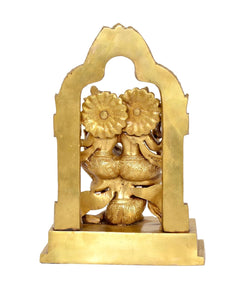 Close view of brass Lakshmi-Narayana figure within arched frame, carved petals