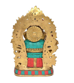 Brass Ganesha idol back view, textured golden halo and colorful red-teal lower body
