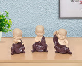 Little Kungfu Buddha monk sculpture, purple resin, hands folded in prayer, front view