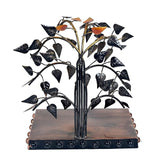 Black iron bodhi tree sculpture with leaf cutouts and Buddha figure on base