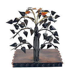 Black iron bodhi tree sculpture with leaf cutouts and Buddha figure on base