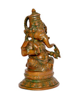 Brass Ganesh idol from the back-left, seated pose with textured crown and arms