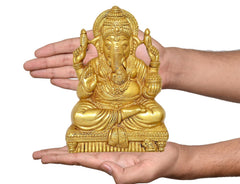 Brass Ganesha wall hanging idol held in hands for size, seated with raised fingers