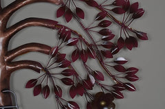 Iron tree wall art close-up with burgundy leaf accents on curved metal branches