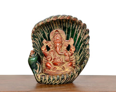 Brass Ganesha in green shankh shell, close-up of painted face and hands