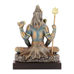 Shiva figurine back view on wooden stand, long hair, trident raised in right hand