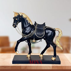 Black horse statue in polyresin, golden mane, ornate saddle with chains on base.