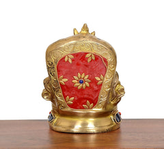 Back of brass Kubera statue, red enamel panel with gold leaf motifs