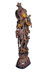 Rear-side view brass Krishna idol with flowing ornaments, detailed carvings on pedestal