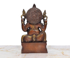 Ganesha brass idol, rear view with carved circular halo and gold accents