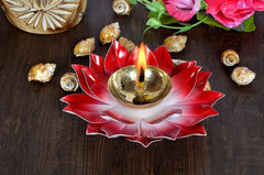 Pink lotus metal diya with gold oil bowl and flame-like wick, red petal base