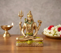 Resin Shiva dashboard sculpture, seated with trident and drum, green base and gold finish