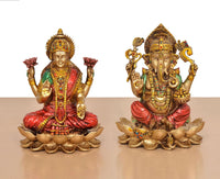 Lakshmi and Ganesh resin statues sitting cross-legged on lotus bases, front view
