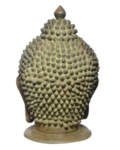 Brass Buddha head statue rear view, dense textured crown and round tabletop base