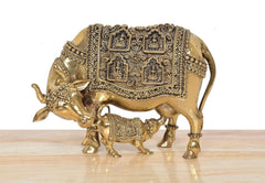 Brass cow with calf showpiece, front view, detailed engraved paneling on body