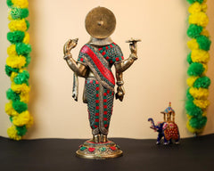 Rear view of brass Dhanvantari statue with jeweled red-green draped garment