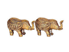 Two golden brass elephants, side view with engraved bodies and raised trunks