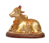 Seated brass Nandi bull figurine with detailed patterned saddle and head markings