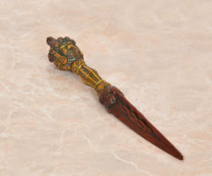 Decorative brass furba phurpa dagger pendant with carved deity head and brown blade