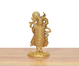Shreenathji brass statue viewed from front-left, ornate crown, arms raised, round base