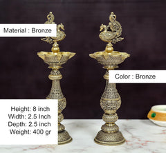 Bronze peacock oil lamp pair, 8 inch height; ornate bowl and engraved stem.