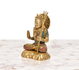 Brass Lord Shiva statue side view, folded hands, trident on round base